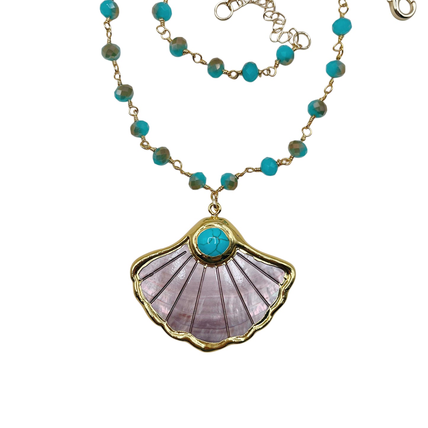 A gold-tone beaded necklace with turquoise blue beads and a scallop-shaped pendant featuring a lavender-pink stone inlay and a turquoise center, shown on a white background.