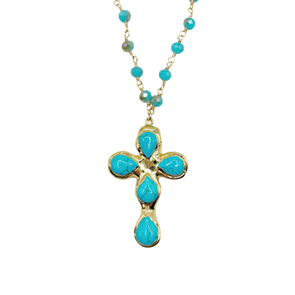 A gold cross pendant necklace featuring five turquoise blue teardrop-shaped stones, suspended from a matching turquoise beaded chain on a white background.