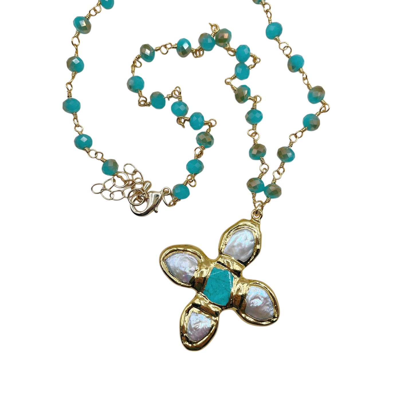 A gold-tone beaded necklace with turquoise blue beads and a central floral pendant featuring white mother-of-pearl petals and a turquoise center, shown on a plain white background.