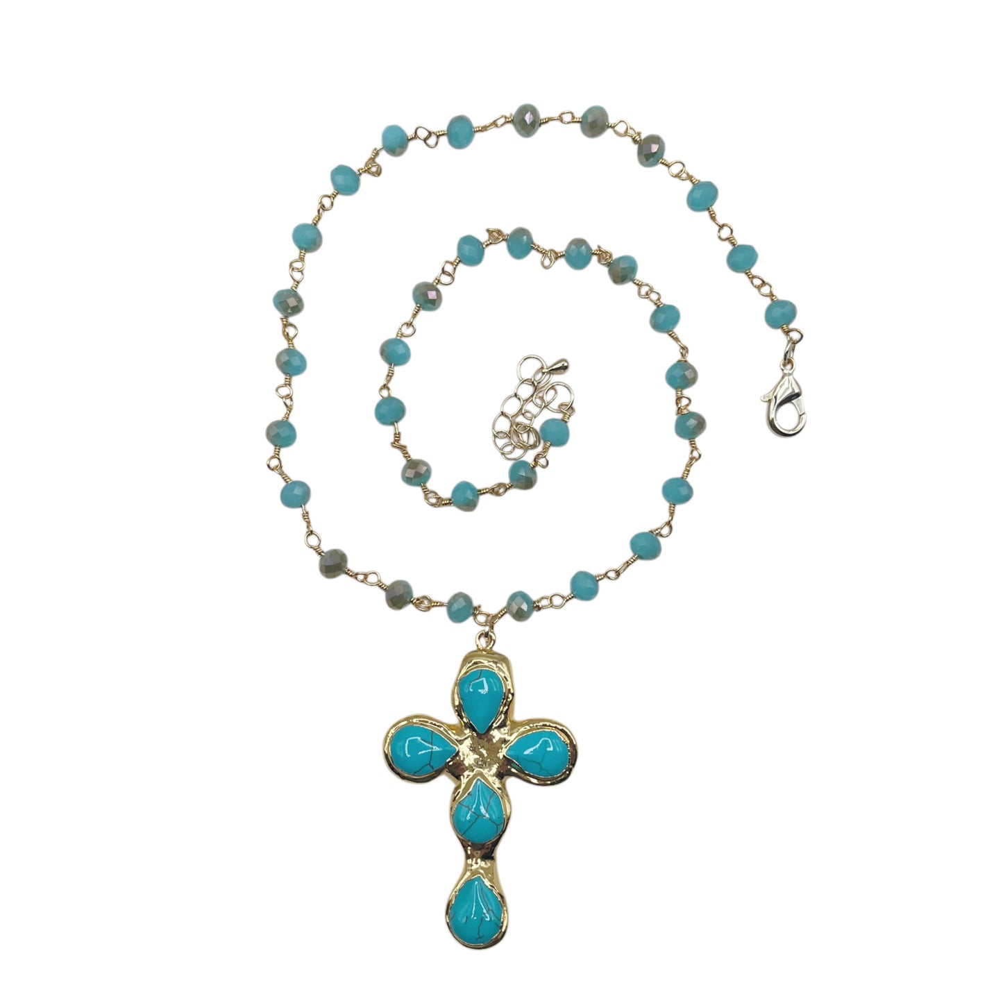 A gold chain necklace featuring turquoise blue beads and a matching cross pendant with turquoise stones, displayed on a clean white background.
