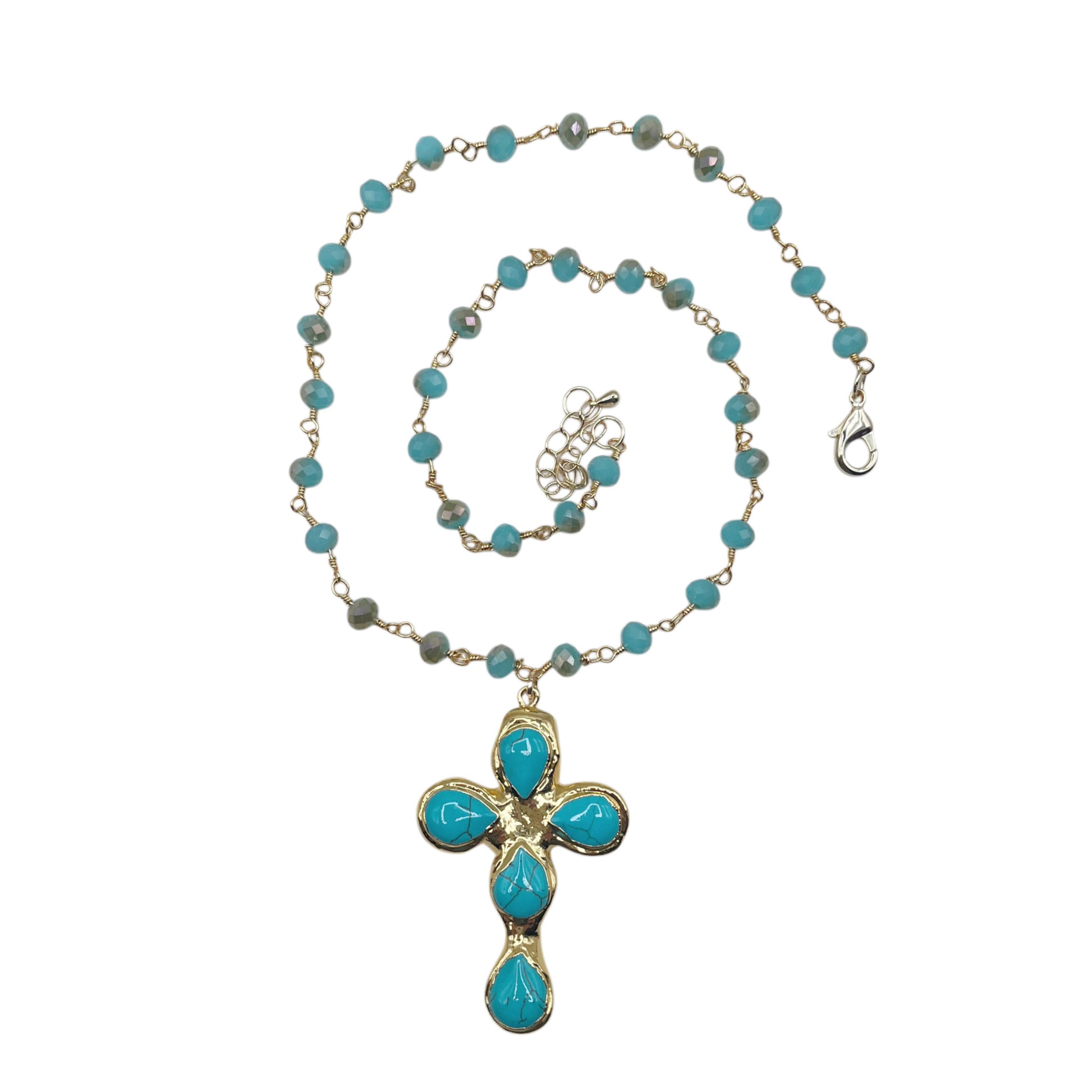 A gold chain necklace featuring turquoise blue beads and a matching cross pendant with turquoise stones, displayed on a clean white background.