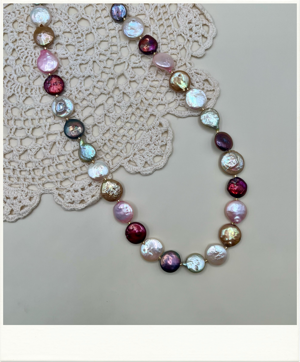 Multicolored coin freshwater pearl necklace on a neutral background