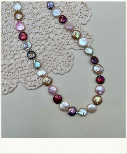 Multicolored coin freshwater pearl necklace on a neutral background