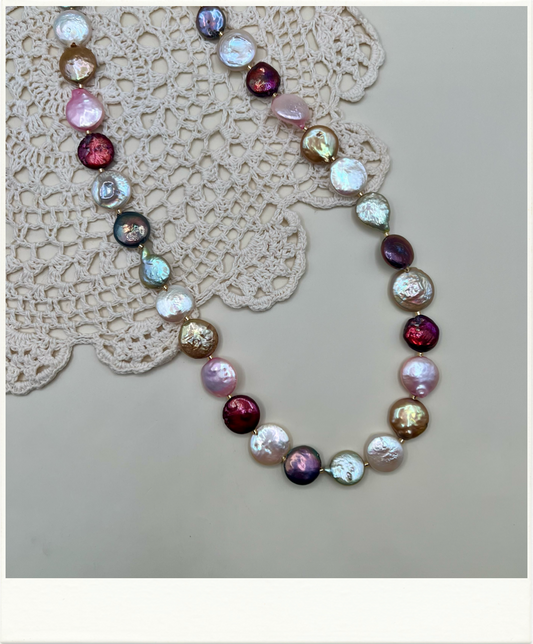 Multicolored coin freshwater pearl necklace on a neutral background