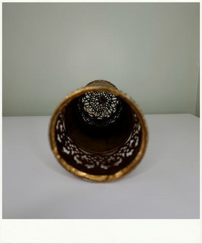 Interior view of vintage brass vanity container showcasing ornate filigree pattern and depth. Cylindrical metal storage piece with decorative mid-century design from Birdie Street.
